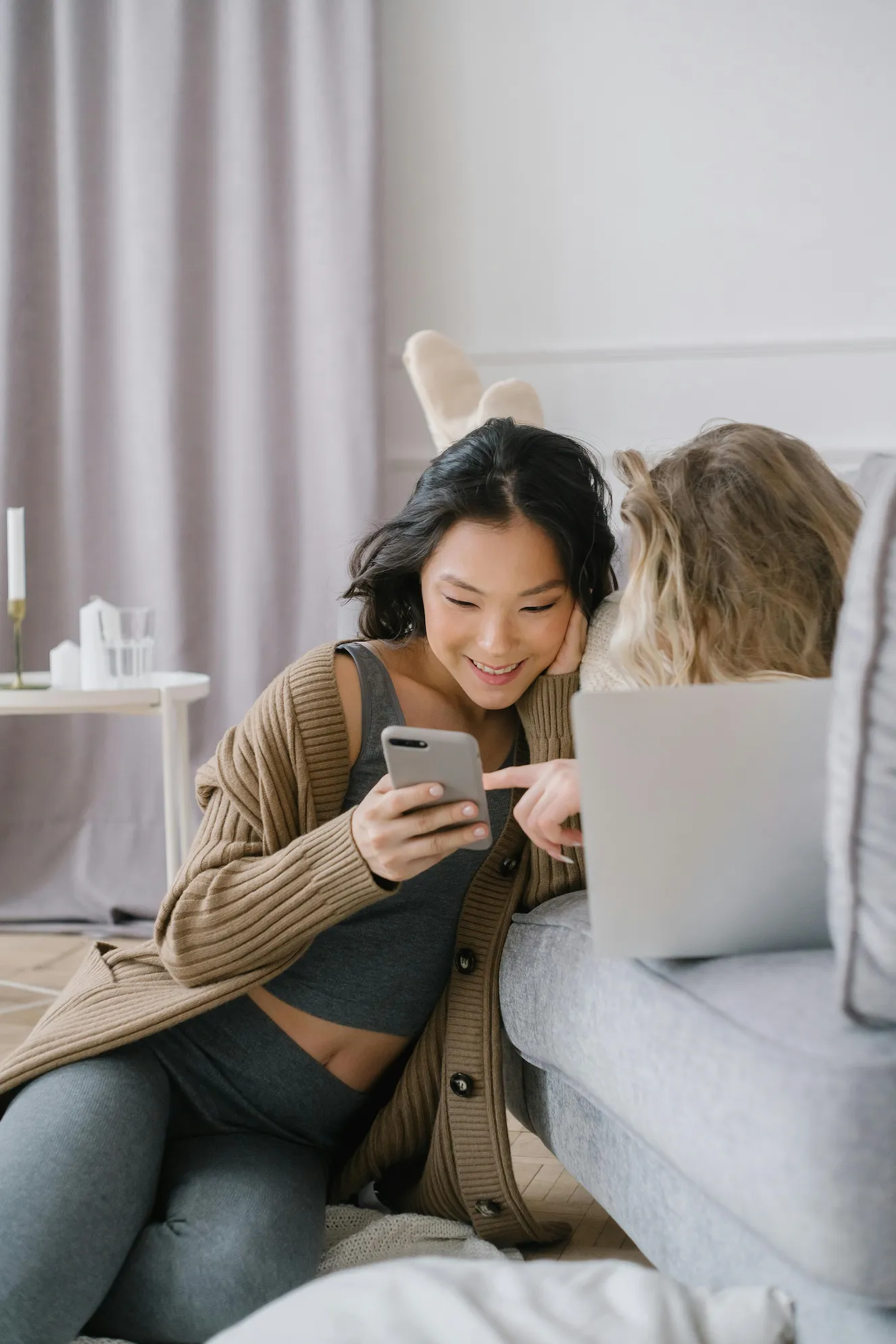 Two people looking at something engaging on a mobile phone