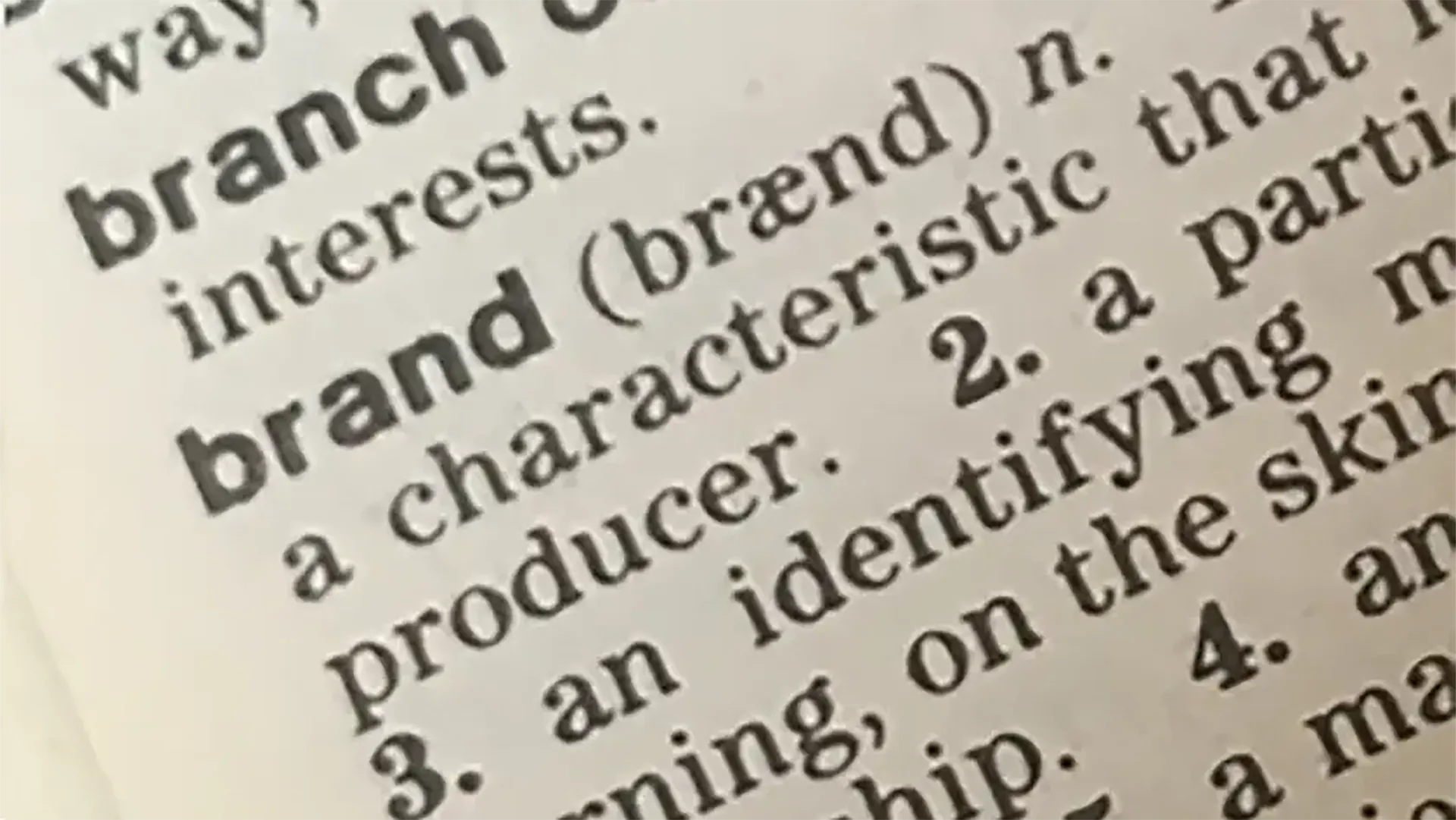 Close-up of the word 'brand' in a dictionary