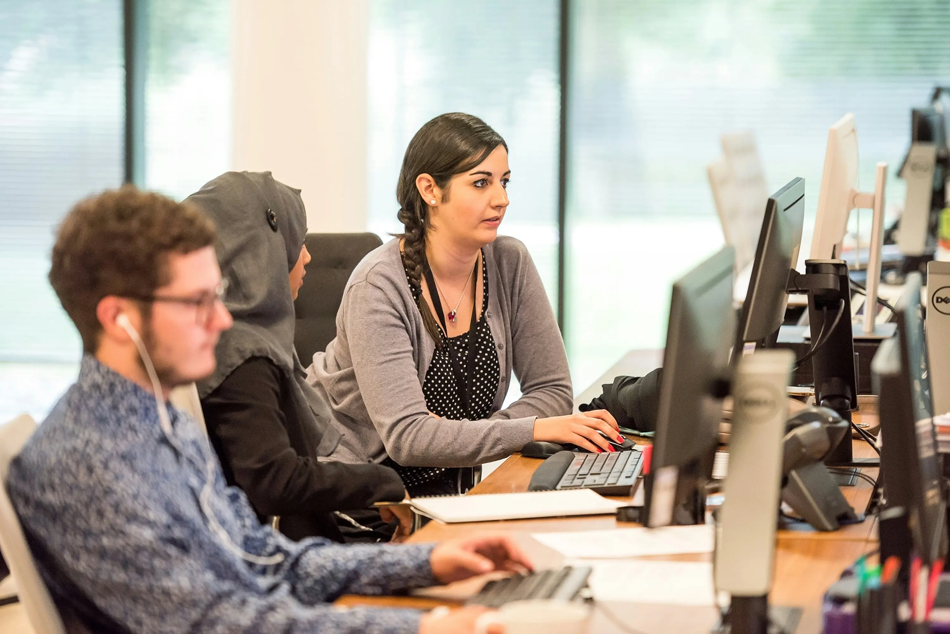 Office workers amid a sea of computer screens